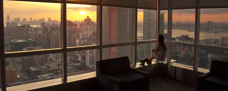 Девушка у окна небоскреба